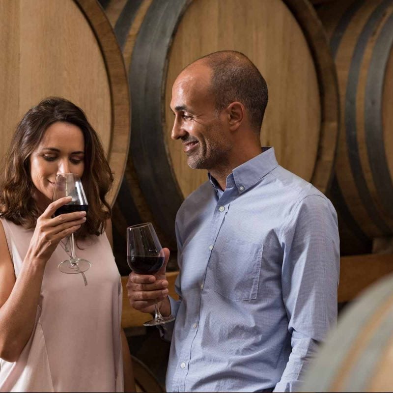 A couple touring the winery cellar